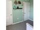 bedroom with neutral green walls with white trim and doors at 16919 Trite Bend St, Wimauma, FL 33598