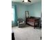 Bedroom with a crib, chair, curtains, and natural light from the window at 16919 Trite Bend St, Wimauma, FL 33598