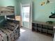 bedroom with a bunk bed, dresser, cubbies, and light from the window at 16919 Trite Bend St, Wimauma, FL 33598