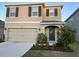 Charming two-story home with a well-manicured lawn and a two car garage, perfect for a Gathering at 16919 Trite Bend St, Wimauma, FL 33598