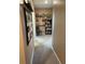 Hallway featuring carpet and decor on the walls leading into another room at 16919 Trite Bend St, Wimauma, FL 33598