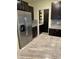 Kitchen with stainless steel refrigerator, dark cabinetry, granite countertops, and pantry at 16919 Trite Bend St, Wimauma, FL 33598