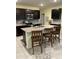 Modern kitchen with dark cabinets, granite countertops, stainless steel appliances, and a center island at 16919 Trite Bend St, Wimauma, FL 33598