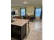 Open concept kitchen flowing into a dining area and living space; perfect for entertaining guests at 16919 Trite Bend St, Wimauma, FL 33598