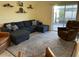 Comfortable living room with plush seating and sliding glass doors at 16919 Trite Bend St, Wimauma, FL 33598
