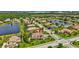 Aerial view of a landscaped single-Gathering home with a screened pool in a lakeside community at 17003 2Nd E Ave, Bradenton, FL 34212