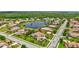 Aerial view of home in a beautiful community near a pond, surrounded by lush greenery and mature landscaping at 17003 2Nd E Ave, Bradenton, FL 34212