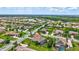 Bird's eye view showing a neighborhood, tree-lined streets, and community lake at 17003 2Nd E Ave, Bradenton, FL 34212