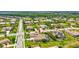 Panoramic aerial shot of a residential area with well-kept lawns, mature trees, and a serene lake at 17003 2Nd E Ave, Bradenton, FL 34212