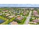 Expansive aerial view of a single-Gathering home with screened pool in a lush landscaped community near a lake at 17003 2Nd E Ave, Bradenton, FL 34212