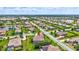 An aerial view of homes in a community surrounding a picturesque lake amid lush greenery at 17003 2Nd E Ave, Bradenton, FL 34212