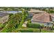 An aerial view showing a backyard with a pool, patio, and well-maintained landscaping next to a lake at 17003 2Nd E Ave, Bradenton, FL 34212