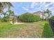 Expansive backyard with manicured lawn, mature trees, and an outdoor seating area for relaxation and entertainment at 17003 2Nd E Ave, Bradenton, FL 34212