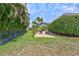 Large backyard featuring lush green lawn, mature trees, and outdoor seating area, perfect for recreation and outdoor enjoyment at 17003 2Nd E Ave, Bradenton, FL 34212