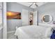 Well-lit bedroom with a white bed, dresser, TV, and a neutral color scheme at 17003 2Nd E Ave, Bradenton, FL 34212