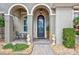 Elegant home entrance featuring an ornate door, sculpted seahorse accents, and inviting outdoor seating at 17003 2Nd E Ave, Bradenton, FL 34212