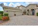 Beautiful home with a three-car garage, manicured bushes, and a paved driveway at 17003 2Nd E Ave, Bradenton, FL 34212