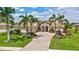 Charming home with a brick driveway, tropical landscaping, and manicured lawn at 17003 2Nd E Ave, Bradenton, FL 34212