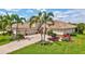 Beautifully landscaped home with a well-manicured lawn and lush tropical foliage at 17003 2Nd E Ave, Bradenton, FL 34212