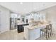 Gourmet kitchen with an island, pendant lighting, stainless steel refrigerator and granite counters at 17003 2Nd E Ave, Bradenton, FL 34212