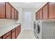 Laundry room featuring cabinets, granite countertops and modern washer and dryer at 17003 2Nd E Ave, Bradenton, FL 34212
