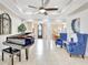 Bright and airy living room featuring a piano, two blue chairs, and elegant finishes at 17003 2Nd E Ave, Bradenton, FL 34212