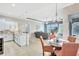 Well-lit living room featuring a modern kitchen, dining area, and a comfortable seating arrangement with a TV at 17003 2Nd E Ave, Bradenton, FL 34212