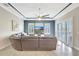 Beautiful living room with tray ceilings, plantation shutters, ceiling fan and large leather sofa at 17003 2Nd E Ave, Bradenton, FL 34212