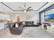 Spacious living room with a large leather sectional couch, plush rug, and adjacent kitchen island with bar seating at 17003 2Nd E Ave, Bradenton, FL 34212