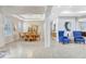 Elegant living room with a dining table, two blue chairs, chandelier and large windows at 17003 2Nd E Ave, Bradenton, FL 34212
