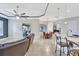 Open concept living room with tile floors, a large sofa, ceiling fan, and lots of natural light at 17003 2Nd E Ave, Bradenton, FL 34212