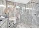Detailed shot of the main bathroom showing the soaking tub and a modern glass shower with decorative tiling at 17003 2Nd E Ave, Bradenton, FL 34212