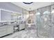Luxurious main bathroom featuring double vanities, a soaking tub, and a frameless glass shower at 17003 2Nd E Ave, Bradenton, FL 34212