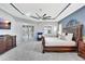 Well-lit main bedroom with a large bed, stylish accent wall, and sliding doors that lead to an outdoor space at 17003 2Nd E Ave, Bradenton, FL 34212