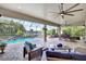 Spacious screened patio features beautiful pool views, outdoor seating, and a ceiling fan at 17003 2Nd E Ave, Bradenton, FL 34212