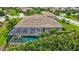 Aerial view of a screened-in pool with clear water and tropical foliage around the backyard at 17003 2Nd E Ave, Bradenton, FL 34212