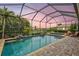 Beautiful pool and spa with a screened enclosure, offering a serene backyard retreat at twilight at 17003 2Nd E Ave, Bradenton, FL 34212