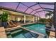 Relaxing screened pool and spa area with lounge chairs, lush landscaping, and resort-style amenities for outdoor enjoyment at 17003 2Nd E Ave, Bradenton, FL 34212