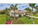 Beautiful home with lush landscaping, including flowers and tropical trees at 17003 2Nd E Ave, Bradenton, FL 34212