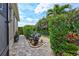 Landscaped side yard with a stone pathway, showcasing meticulous garden design and curb appeal at 17003 2Nd E Ave, Bradenton, FL 34212
