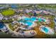 Aerial view of a luxurious resort-style pool complex with multiple pools, a spa, and meticulously landscaped grounds at 17640 Northwood Pl, Bradenton, FL 34202