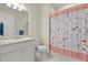 Clean bathroom with a white vanity, a standard toilet, and a shower with patterned curtain at 17640 Northwood Pl, Bradenton, FL 34202