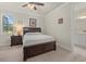 Cozy bedroom features an end table and a dark wood bed frame with storage at 17640 Northwood Pl, Bradenton, FL 34202