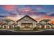 Elegant building facade with stone accents and palm trees under a vibrant sunset sky at 17640 Northwood Pl, Bradenton, FL 34202