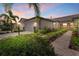 Beautiful home exterior with manicured landscaping, a tile roof and three-car garage at 17640 Northwood Pl, Bradenton, FL 34202