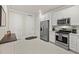 Modern kitchen featuring stainless steel appliances, white cabinetry and tiled flooring at 17640 Northwood Pl, Bradenton, FL 34202