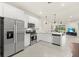 Bright kitchen with stainless steel appliances, white cabinets and breakfast bar overlooking the living area at 17640 Northwood Pl, Bradenton, FL 34202