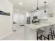 Stylish kitchen with white cabinets, stainless steel appliances, and center island with seating at 17640 Northwood Pl, Bradenton, FL 34202