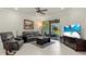 Beautifully decorated living room, featuring tiled floors, ceiling fan and sliding doors to the lanai at 17640 Northwood Pl, Bradenton, FL 34202