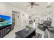 Bright living room featuring neutral tiling, a ceiling fan, and comfortable seating at 17640 Northwood Pl, Bradenton, FL 34202